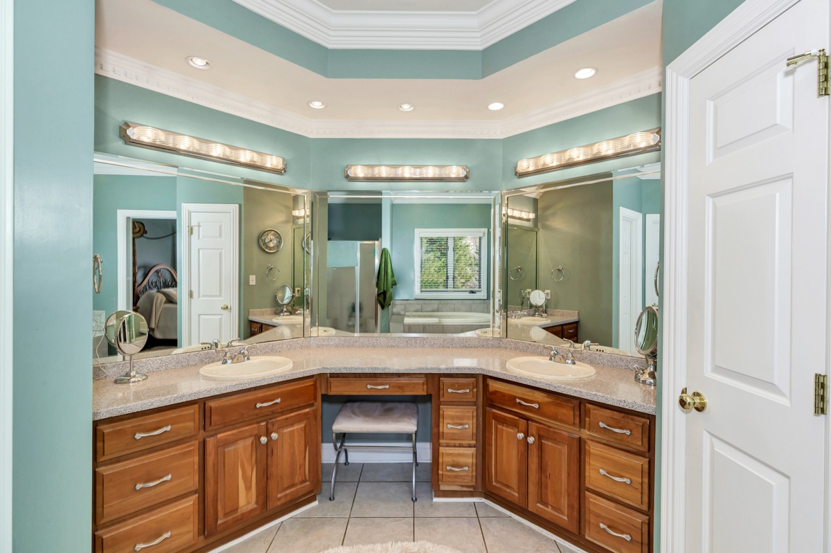 18789 Wells Road Athens, AL 35613 - Photo 16 of 40 a bathroom with a sink double vanity and a large mirror