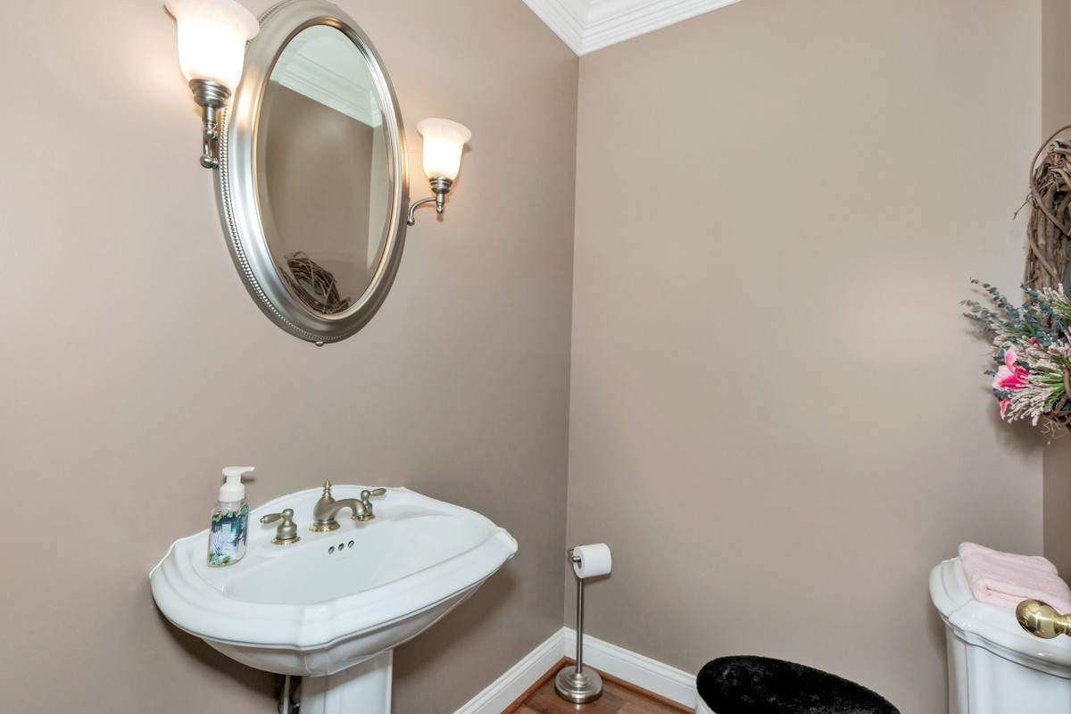18789 Wells Road Athens, AL 35613 - Photo 22 of 40 a bathroom with a sink a mirror and a toilet
