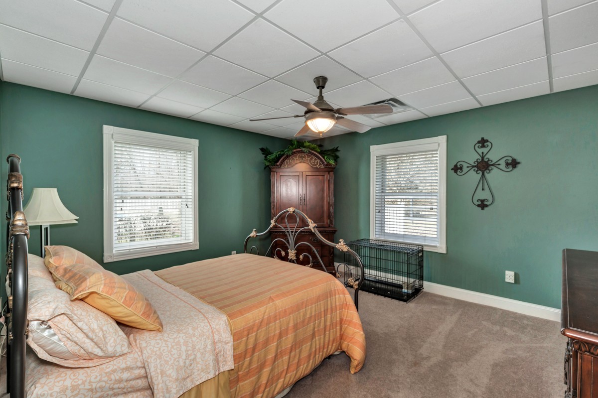 18789 Wells Road Athens, AL 35613 - Photo 25 of 40 a bedroom with a bed and a chandelier