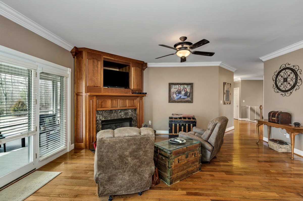 18789 Wells Road Athens, AL 35613 - Photo 8 of 40 a living room with furniture a fireplace and a flat screen tv