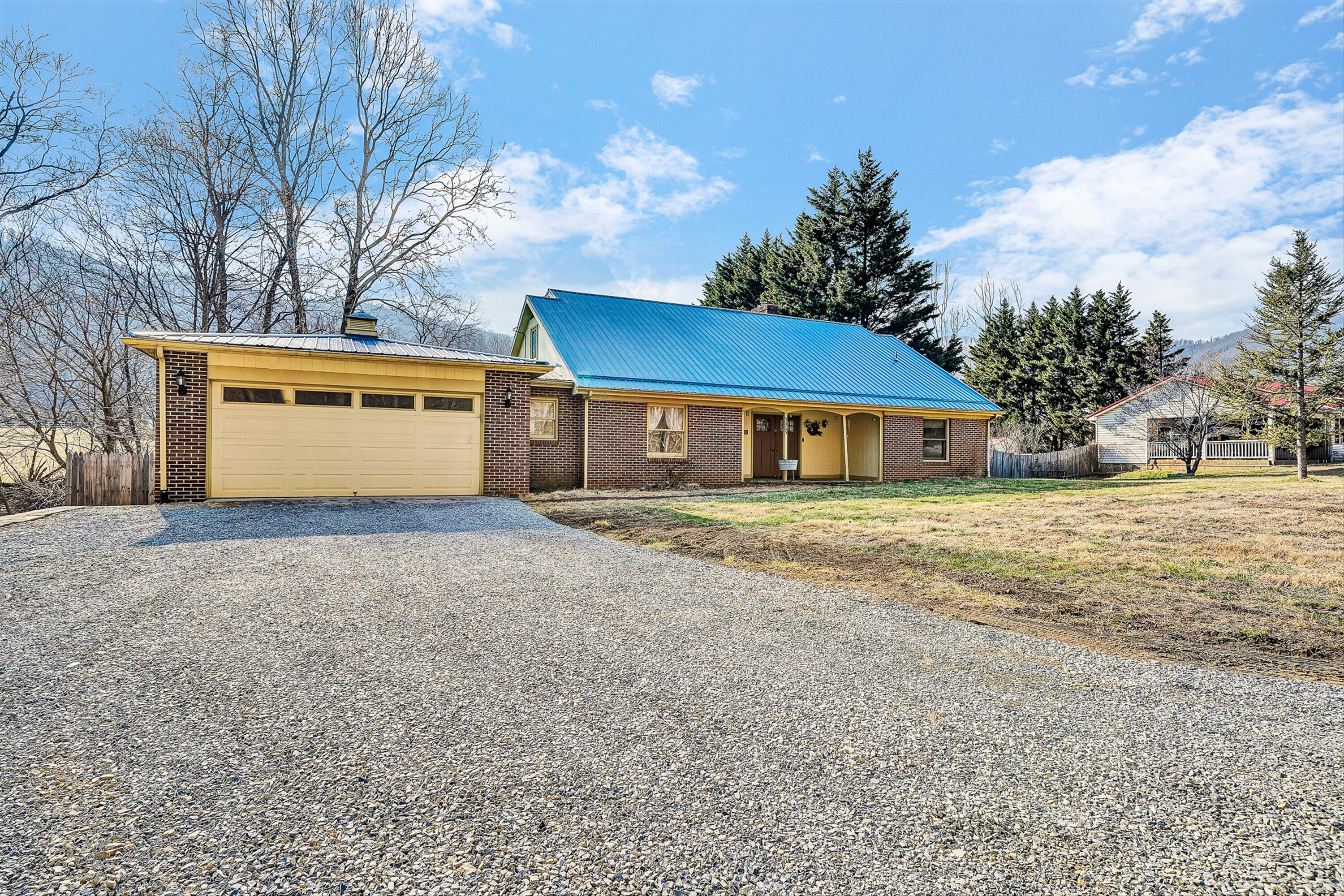 3305 Naff Road Boones Mill, VA 24065 - Photo 1 of 57 a front view of a house with a yard and garage