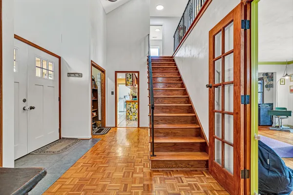 a view of an entryway with wooden floor and stairs