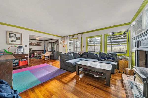 a living room with furniture a rug and a floor to ceiling window