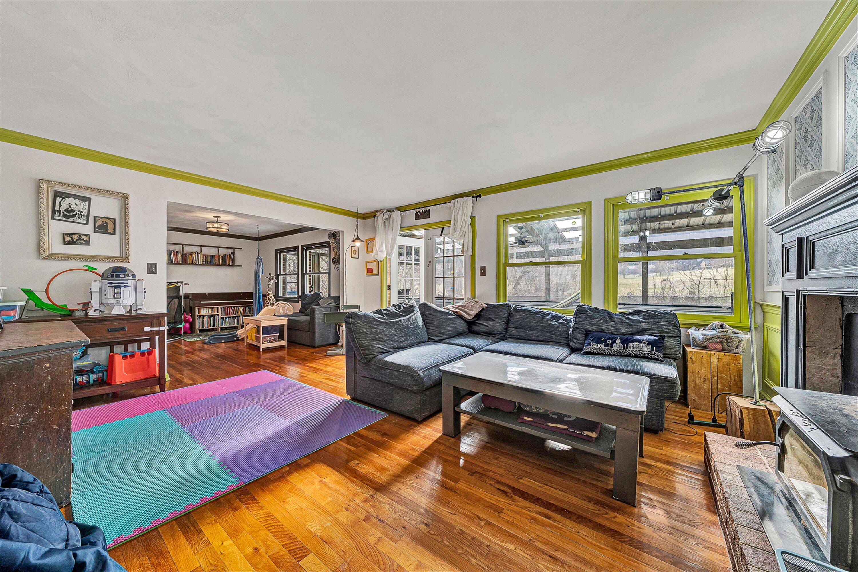 3305 Naff Road Boones Mill, VA 24065 - Photo 12 of 57 a living room with furniture a rug and a floor to ceiling window