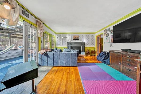 a living room with furniture a flat screen tv and a fireplace