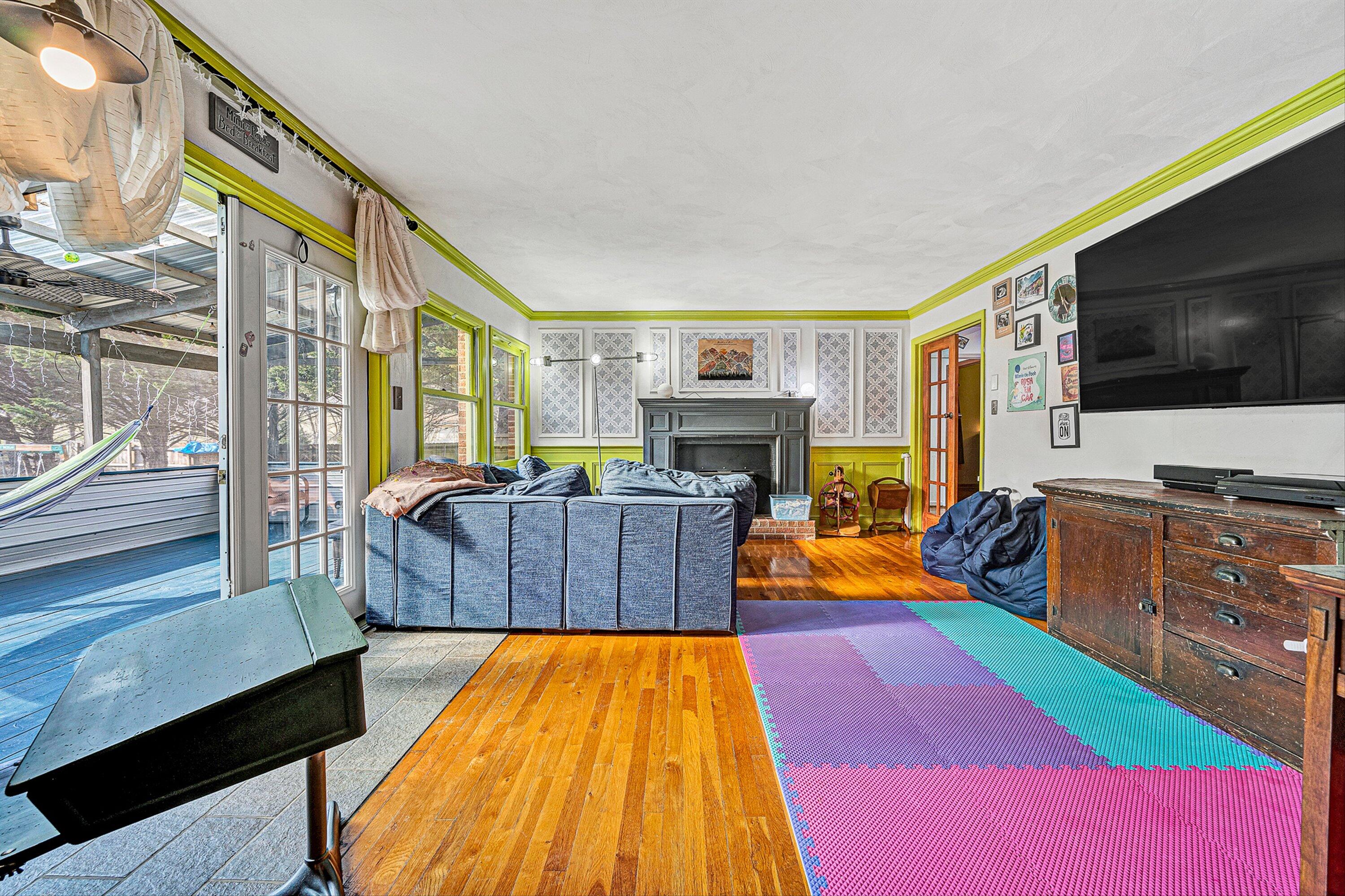 3305 Naff Road Boones Mill, VA 24065 - Photo 14 of 57 a living room with furniture a flat screen tv and a fireplace