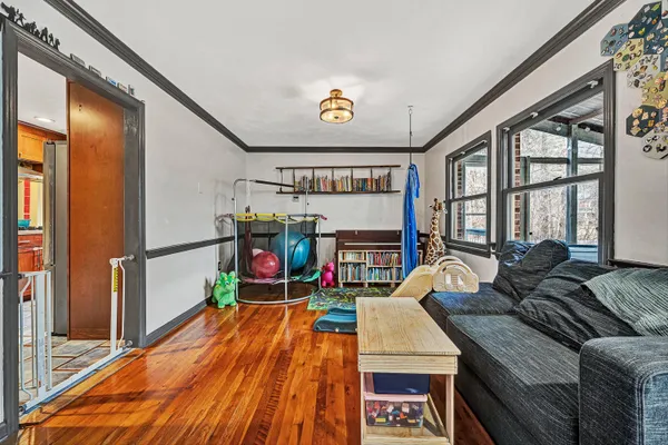 a living room with furniture and a floor to ceiling window