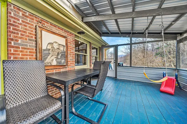 a balcony with wooden floors and outdoor seating