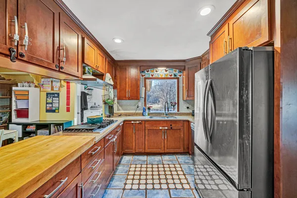 a kitchen with stainless steel appliances granite countertop a refrigerator and sink