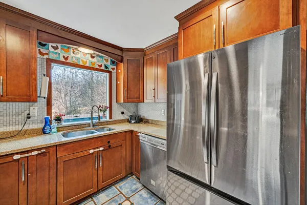 a kitchen with stainless steel appliances a sink and a large window