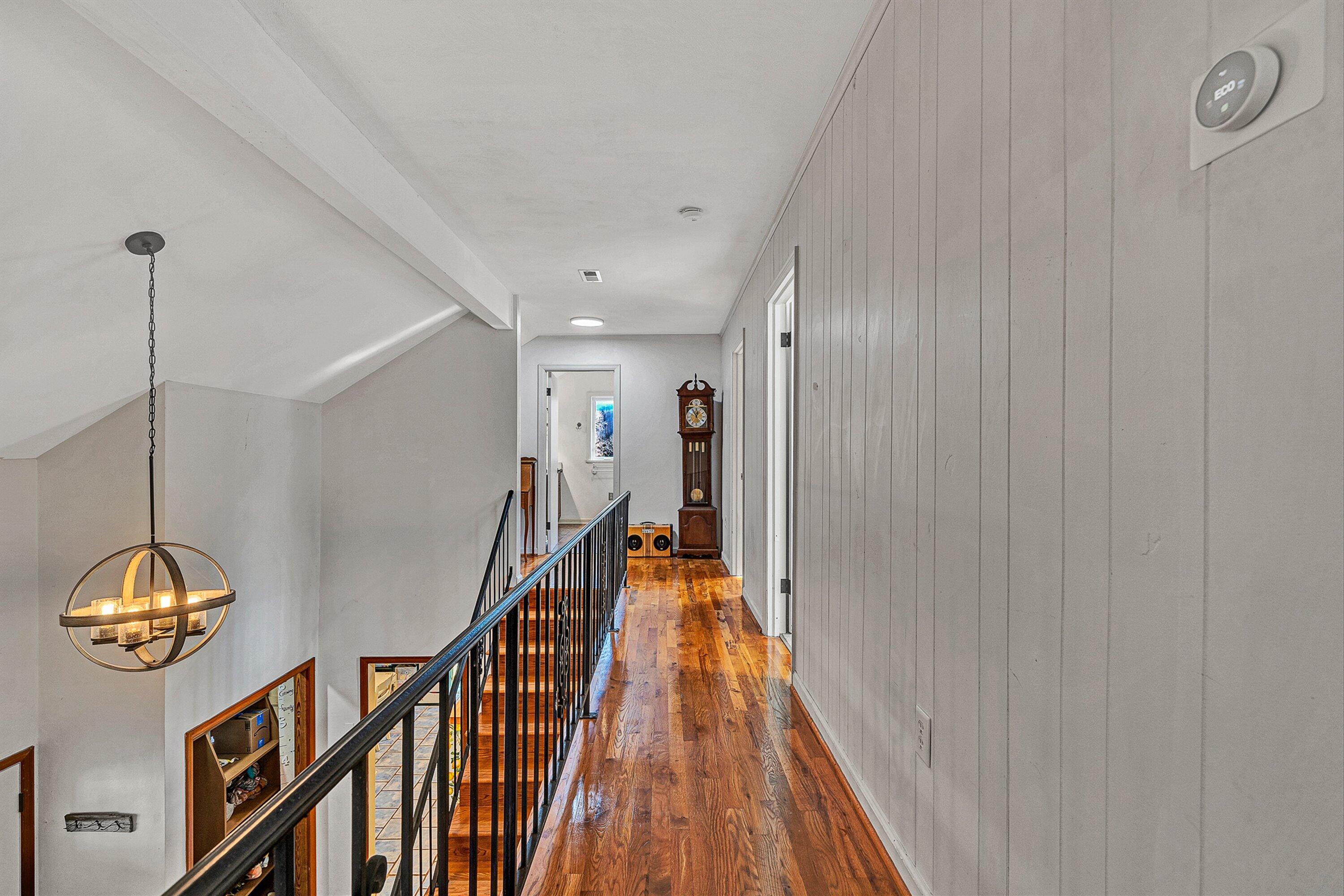 3305 Naff Road Boones Mill, VA 24065 - Photo 30 of 57 a view of a hallway with wooden floor and stairs