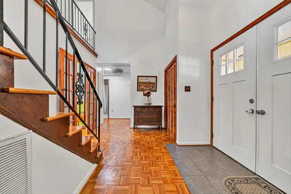 a view of a hallway with wooden floor and staircase