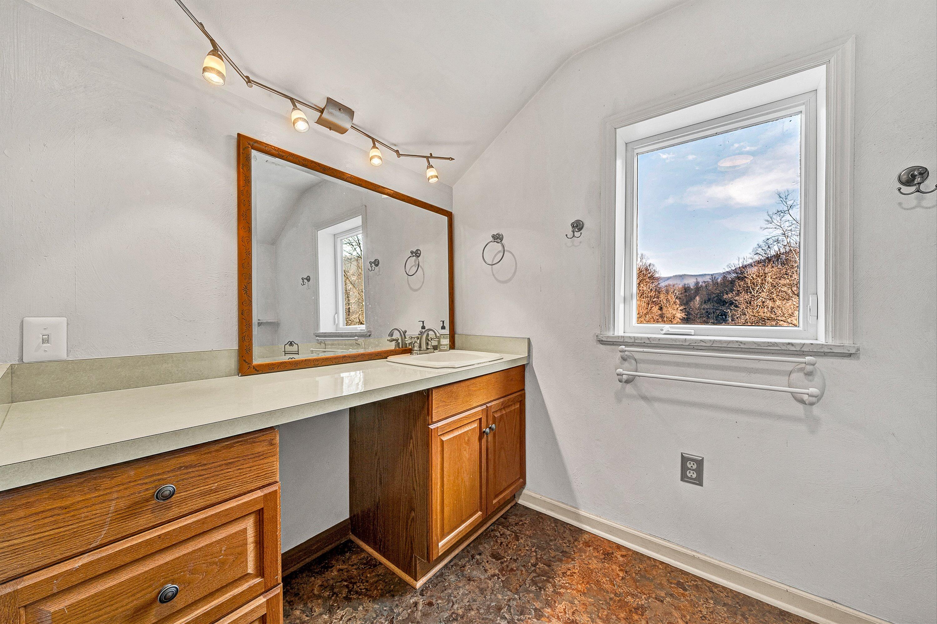 3305 Naff Road Boones Mill, VA 24065 - Photo 36 of 57 a bathroom with a granite countertop sink mirror and window