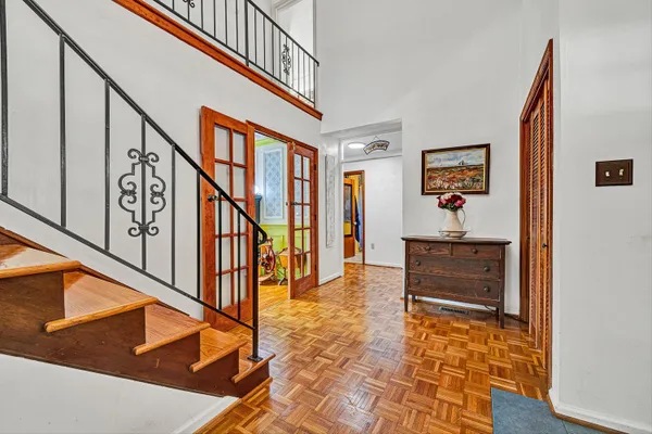 a view of staircase with lots of frames on wall and a window