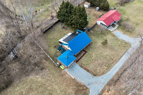 a view of a backyard with wooden fence