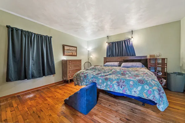 a bedroom with a bed and a dresser