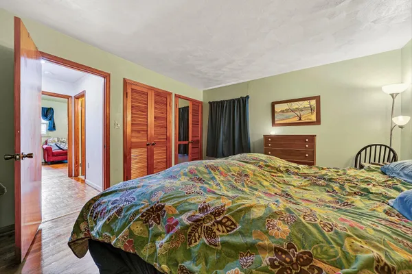 a bedroom with a bed and a dresser