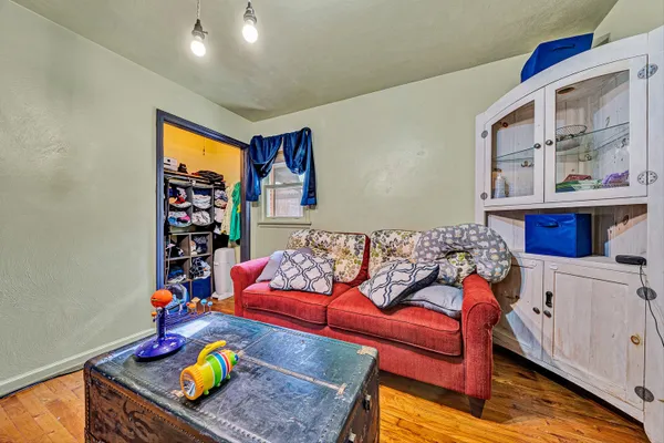 a living room with furniture and wooden floor