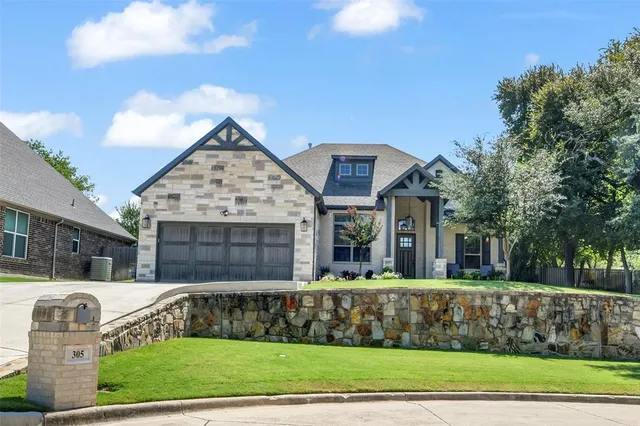 a front view of houses with yard