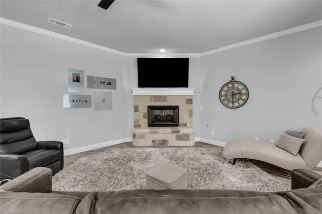 a living room with furniture a fireplace and a flat screen tv