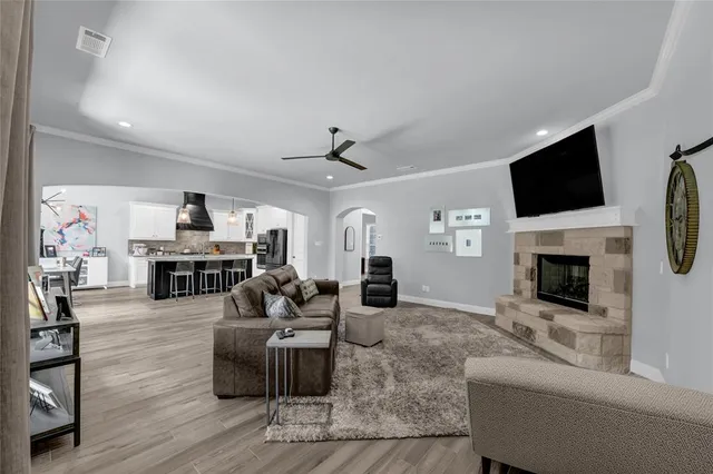 a living room with fireplace furniture and a flat screen tv