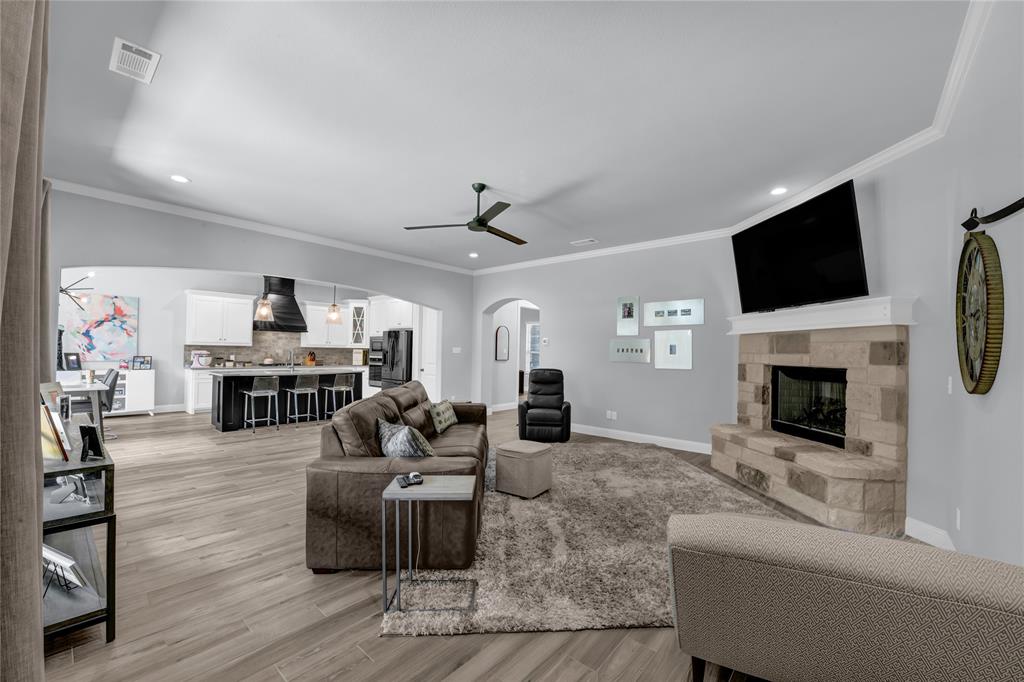 305 Familia Court Azle, TX 76020 - Photo 13 of 40 a living room with furniture a fireplace and a flat screen tv