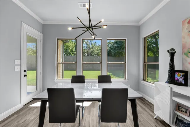 a large kitchen with a table and chairs