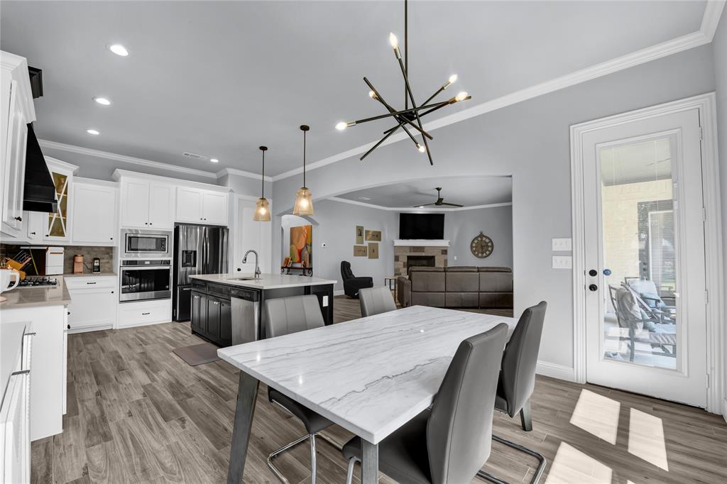 305 Familia Court Azle, TX 76020 - Photo 16 of 40 a large kitchen with a table and chairs