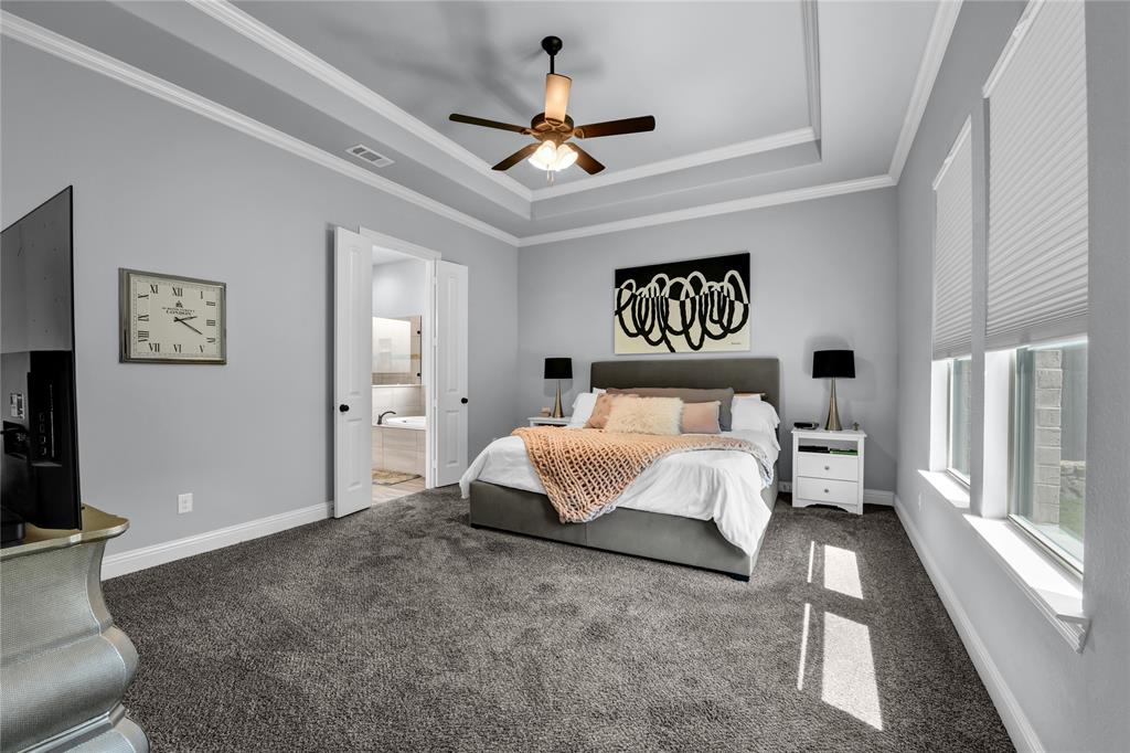 305 Familia Court Azle, TX 76020 - Photo 18 of 40 a spacious bedroom with a bed and a chandelier