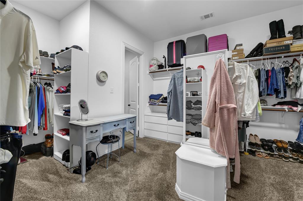 305 Familia Court Azle, TX 76020 - Photo 22 of 40 a view of walk in closet with clothes and shoes