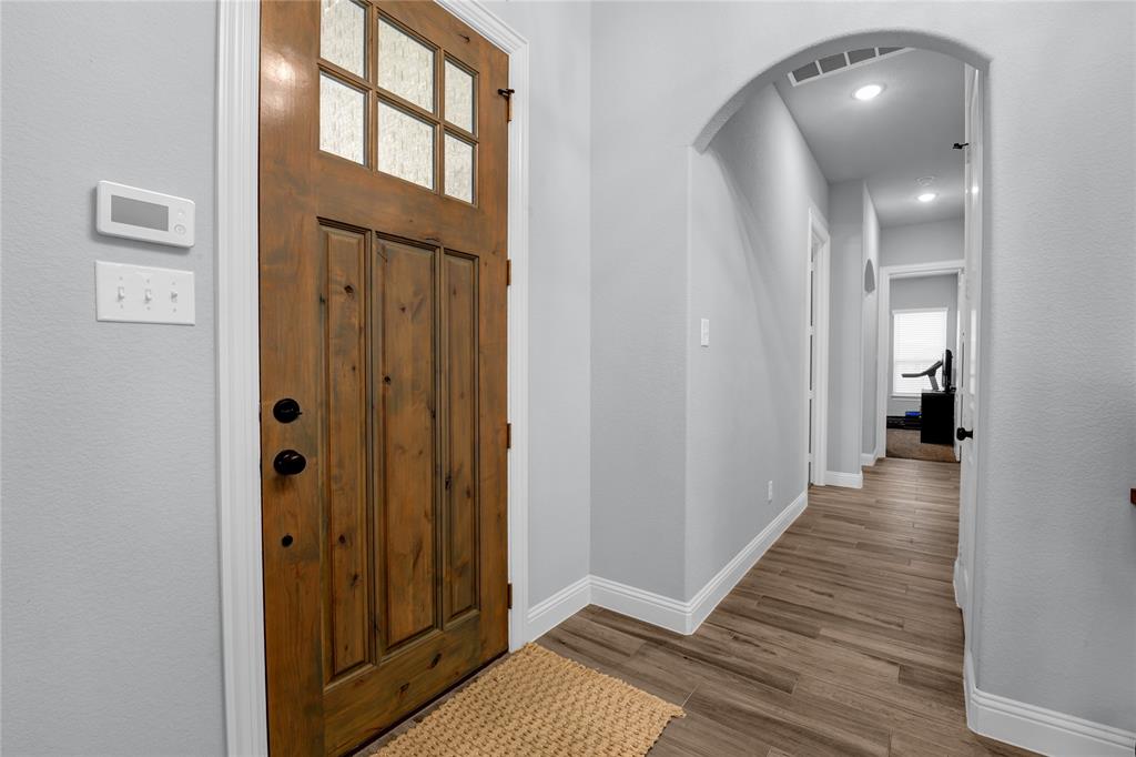 305 Familia Court Azle, TX 76020 - Photo 24 of 40 a view of a hallway with wooden floor and staircase