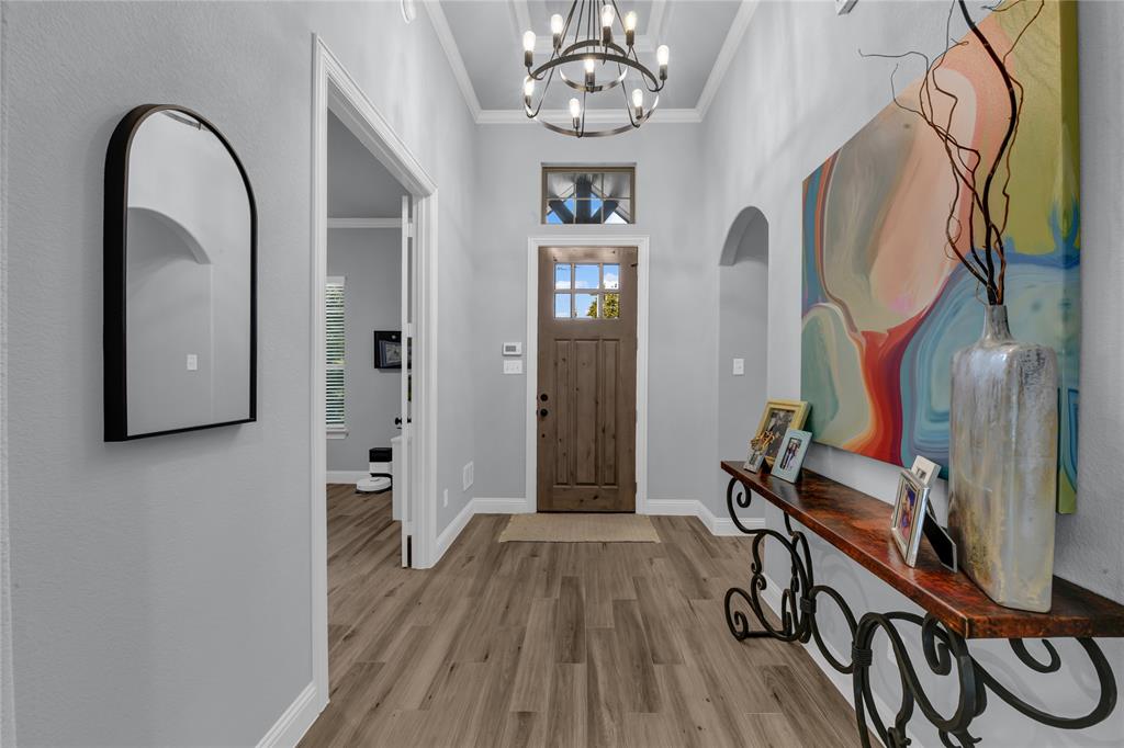 305 Familia Court Azle, TX 76020 - Photo 25 of 40 a view of a hallway with wooden floor and stairs