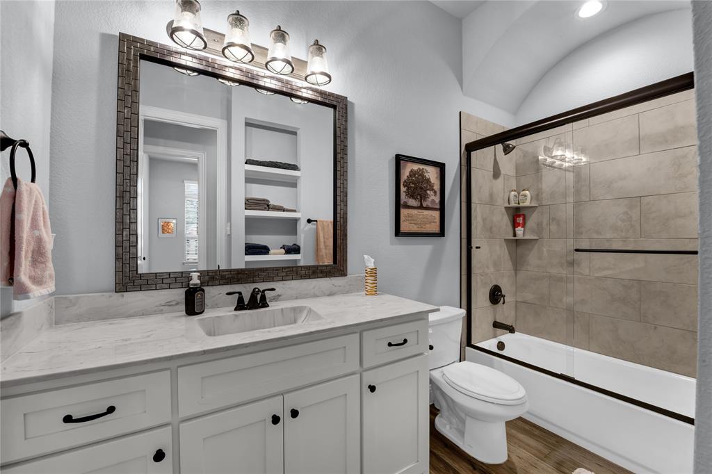 305 Familia Court Azle, TX 76020 - Photo 27 of 40 a bathroom with a double vanity sink toilet mirror and shower
