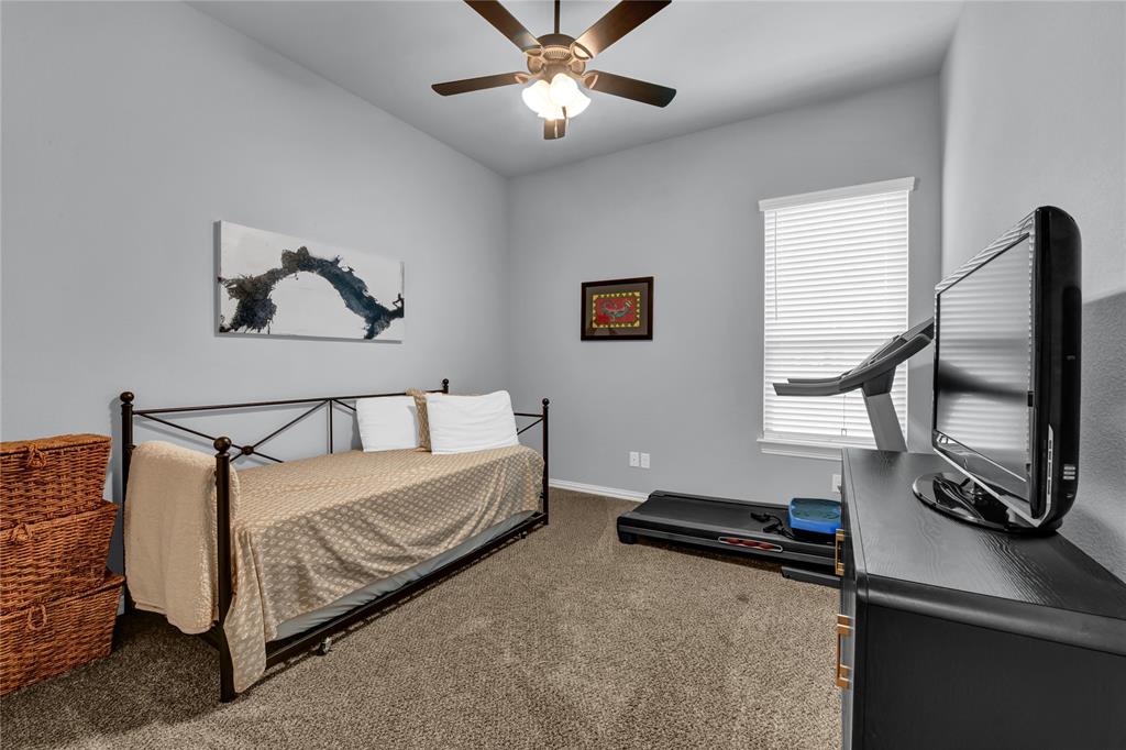 305 Familia Court Azle, TX 76020 - Photo 28 of 40 a bedroom with bed and a chandelier