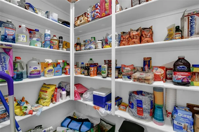 a view of a house with a yard and potted plants