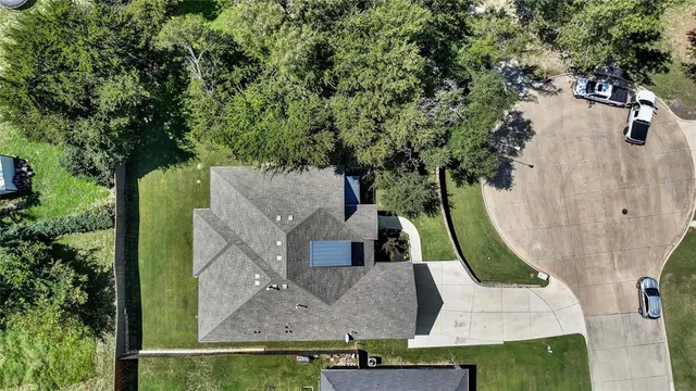 a view of a house with a yard and tree s