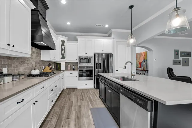a kitchen with a sink and a chandelier