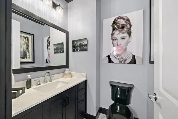 a bathroom with a sink mirror and vanity