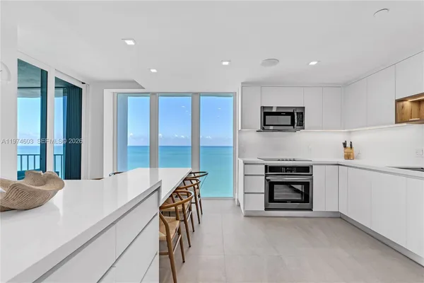 a kitchen with stainless steel appliances a refrigerator sink and microwave