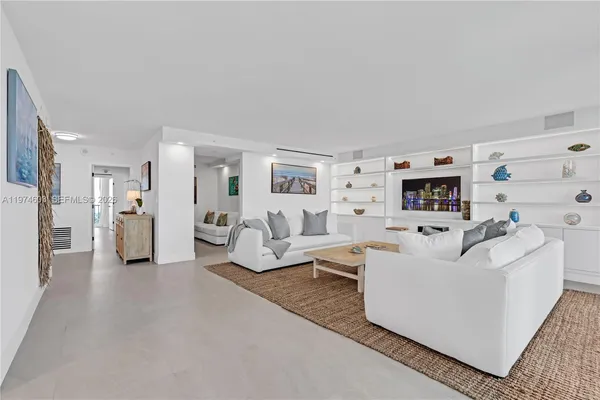 a living room with furniture and a mirror