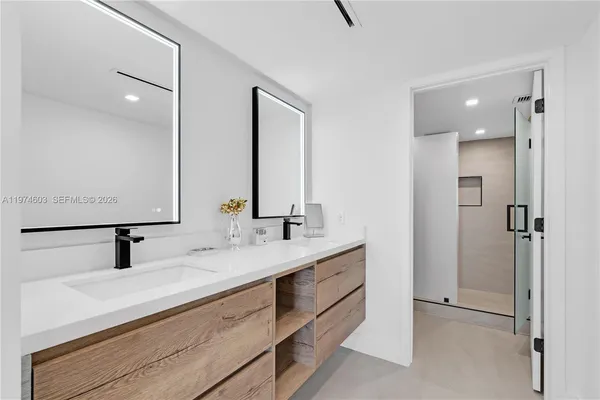 a bathroom with a double vanity sink and a mirror