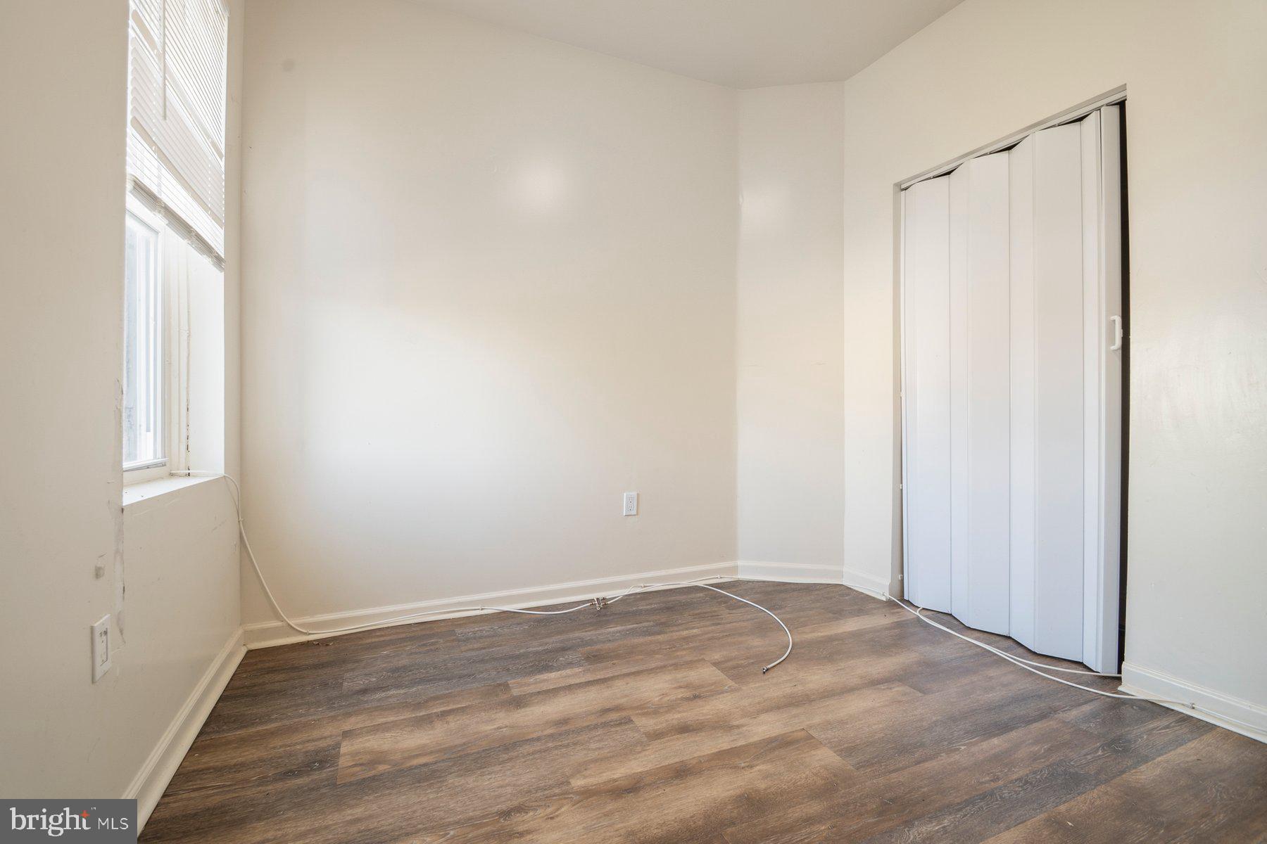 322 South Pulaski Street Baltimore, MD 21223 - Photo 16 of 28 a view of a small space with wooden floor and a window