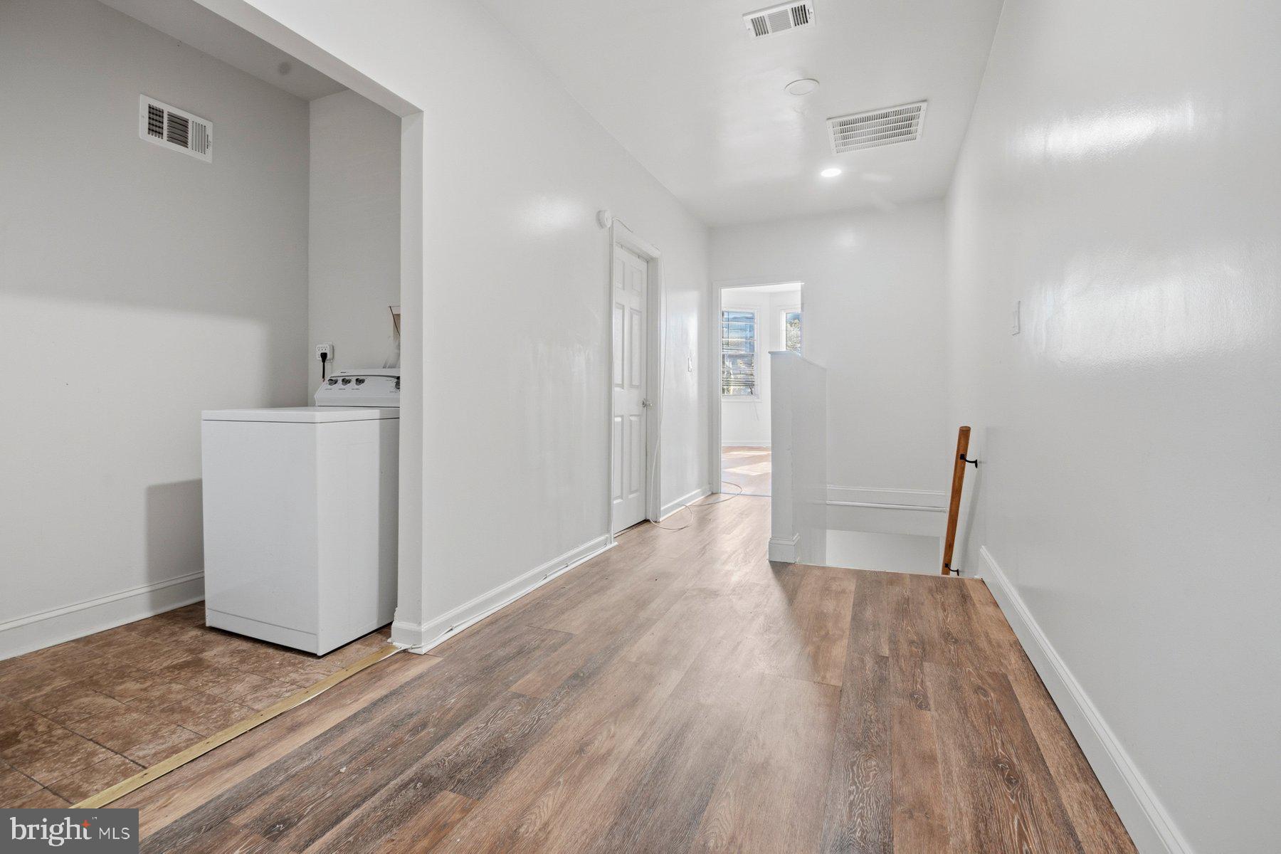322 South Pulaski Street Baltimore, MD 21223 - Photo 17 of 28 a view of empty room with wooden floor