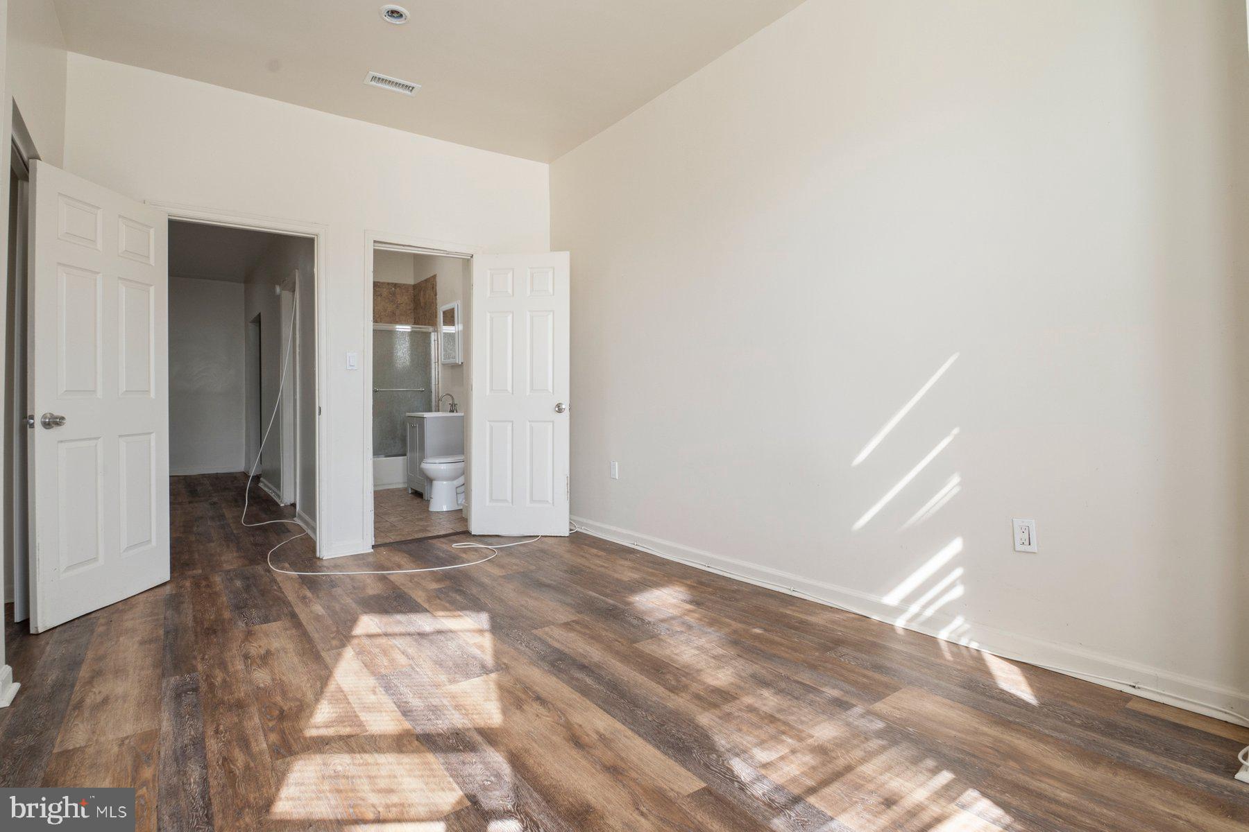 322 South Pulaski Street Baltimore, MD 21223 - Photo 23 of 28 a view of a big room with closet and wooden floor