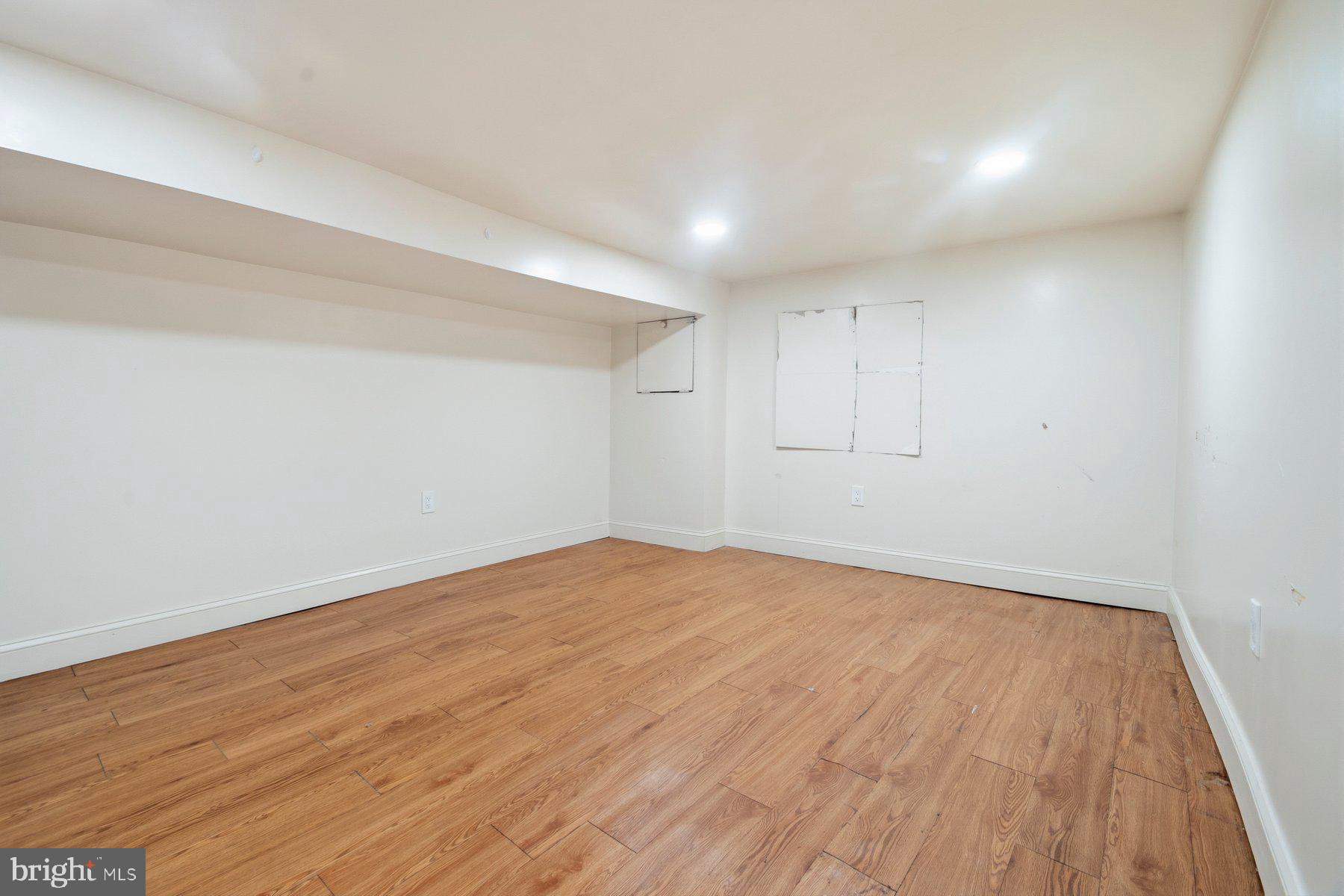 322 South Pulaski Street Baltimore, MD 21223 - Photo 24 of 28 a view of empty room with wooden floor