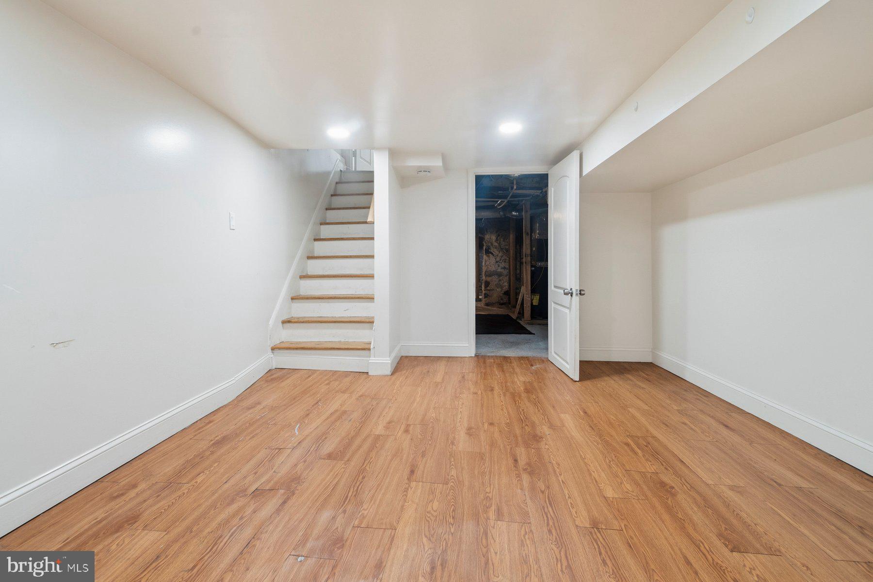 322 South Pulaski Street Baltimore, MD 21223 - Photo 25 of 28 a view of entryway with stairs and wooden floor