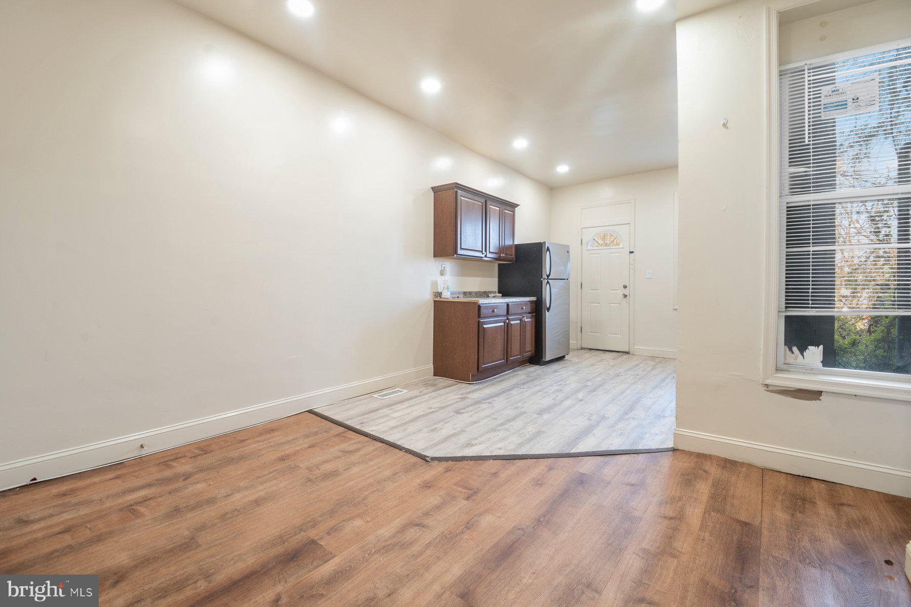 322 South Pulaski Street Baltimore, MD 21223 - Photo 7 of 28 an empty room with wooden floor and windows