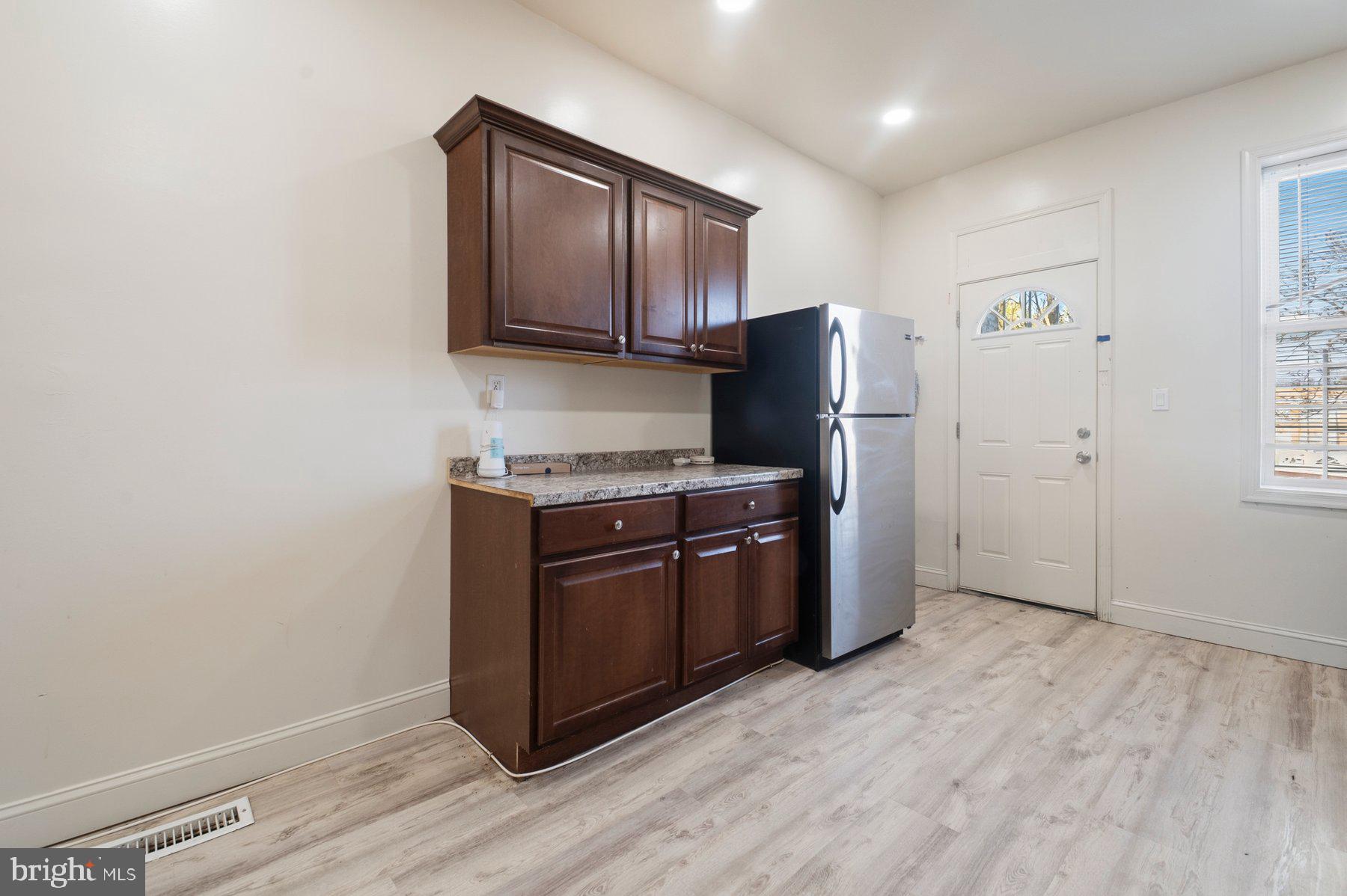 322 South Pulaski Street Baltimore, MD 21223 - Photo 10 of 28 a kitchen with stainless steel appliances granite countertop a refrigerator stove and microwave