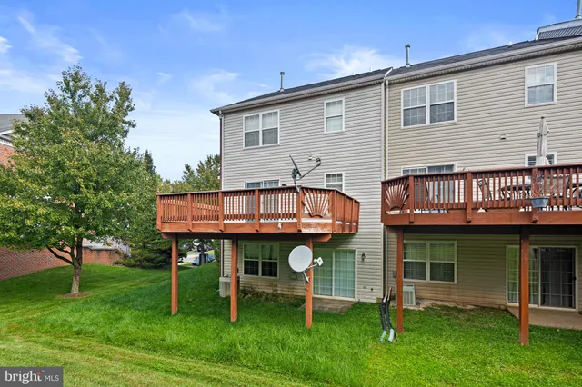 a view of house with a yard and sitting area