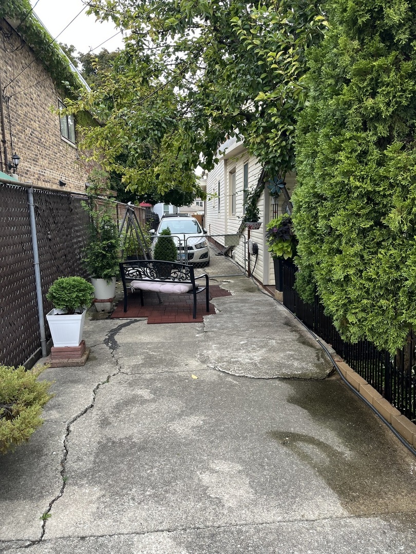 3331 West 64th Street Chicago, IL 60629 - Photo 13 of 15 a view of a patio with table and chairs and potted plants